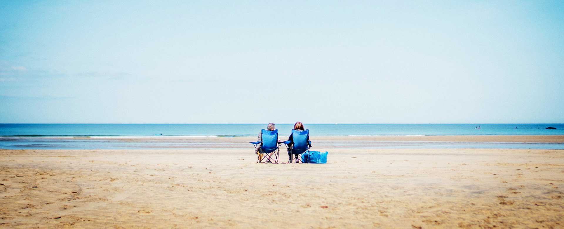 people on the beach for main image in a blog about saving money on an obx vacation
