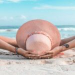 Woman laying in the sand on the beach