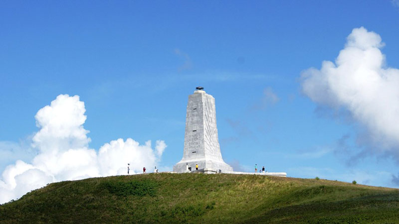 The climb to the top of the Wright Brothers Monument is well worth it for you and your dog. 