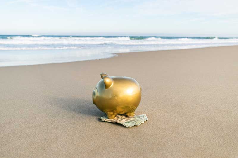 Gold piggy bank showcasing money earned when renting your OBX vacation home. 