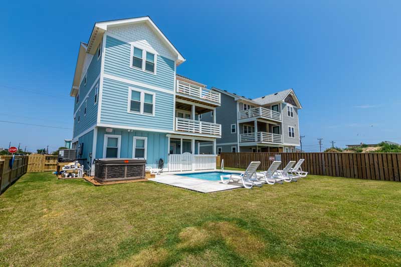 A Kitty Hawk vacation home with private pool and hot tub for entertaining Outer Banks visitors. 