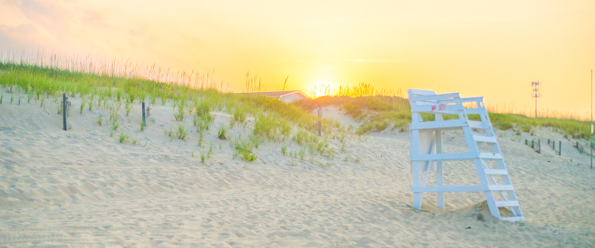 Secluded lifeguard stand at sunset on a Nags Head beach on the Outer Banks of North Carolina.